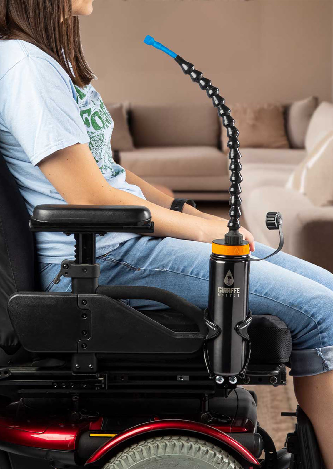 Assistive Technology woman in motorized wheelchair drinking from assistive technology hydration system