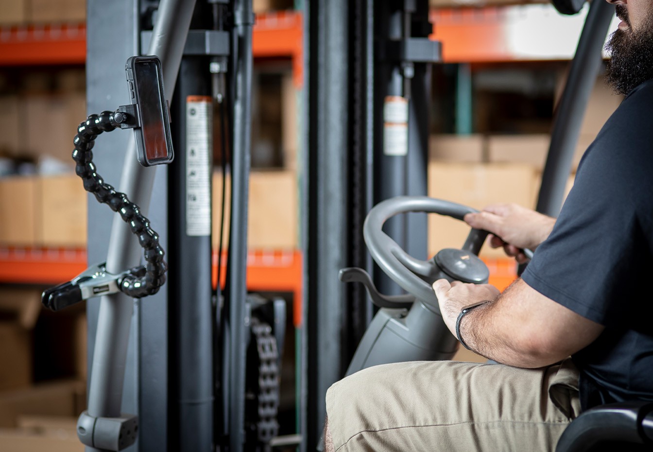 partner-with-us A close-up photo of a green acorn hanging from a branch on an oak tree. The acorn is partially covered by a leafy cap.